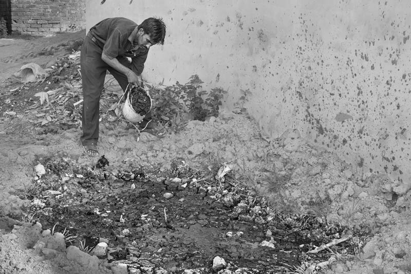 Untreated fecal sludge collected from a septic tank being disposed in open environment at a vacant plot in a peri-urban colony in Bareilly city, Uttar Pradesh